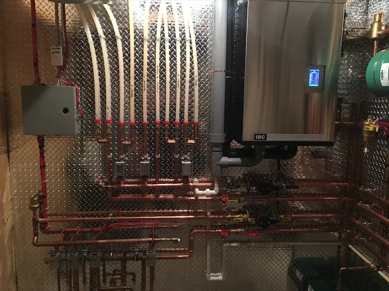 Copper manifold and circulators alongside a stainless condensing boiler