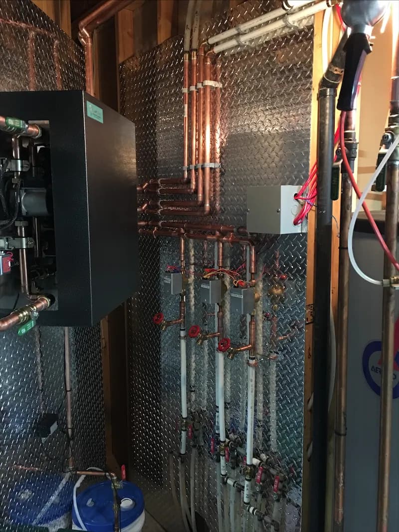 Boiler control cabinet and copper piping in a residential mechanical room